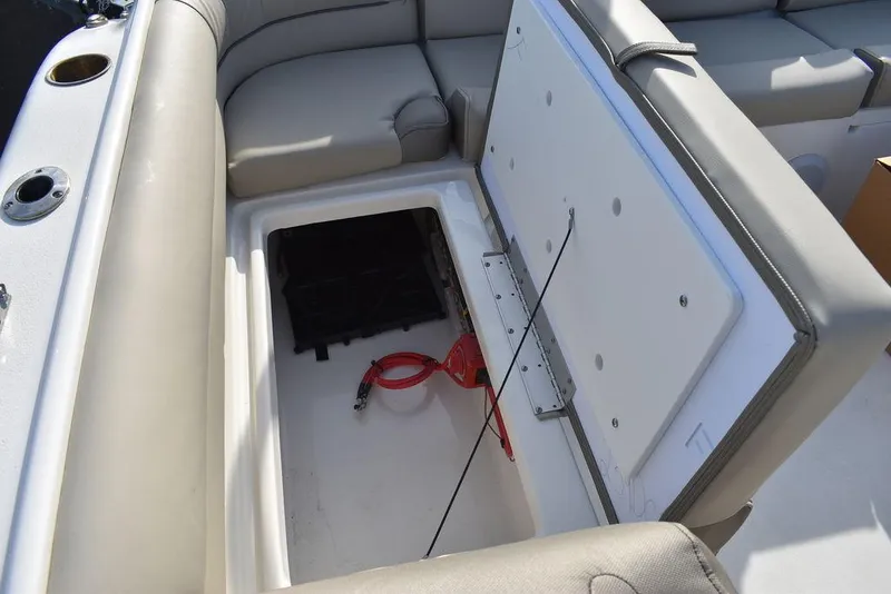 Slide: The Image of 2024 Key West 239 DFS boat storage compartment with seating and cup holders. - 34