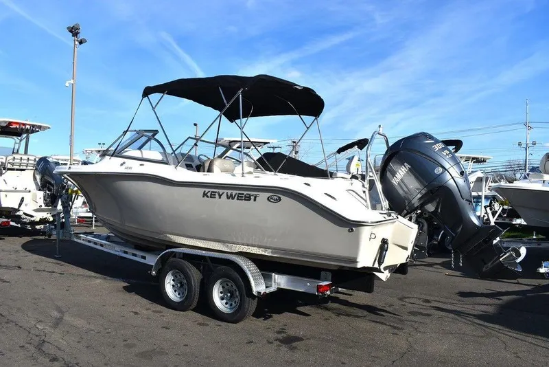 Slide: The Image of 2024 Key West 239 DFS boat on trailer, outdoor display, sunny day. - 4