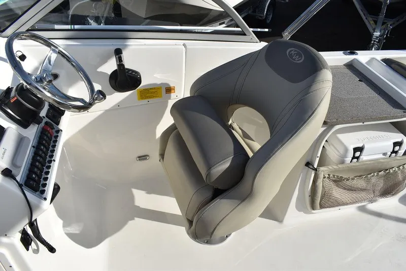 Slide: The Image of 2024 Key West 239 DFS boat interior with steering wheel and cushioned seat. - 42