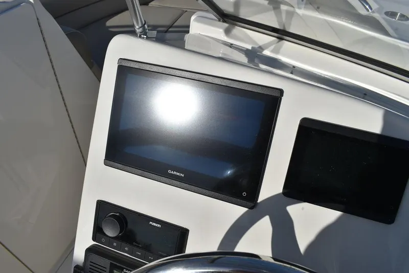 Slide: The Image of 2024 Key West 239 DFS boat dashboard with Garmin display and controls. - 45