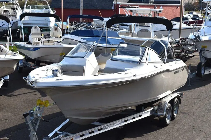 Slide: The Image of 2024 Key West 239 DFS boat on trailer, surrounded by other boats in a marina. - 8
