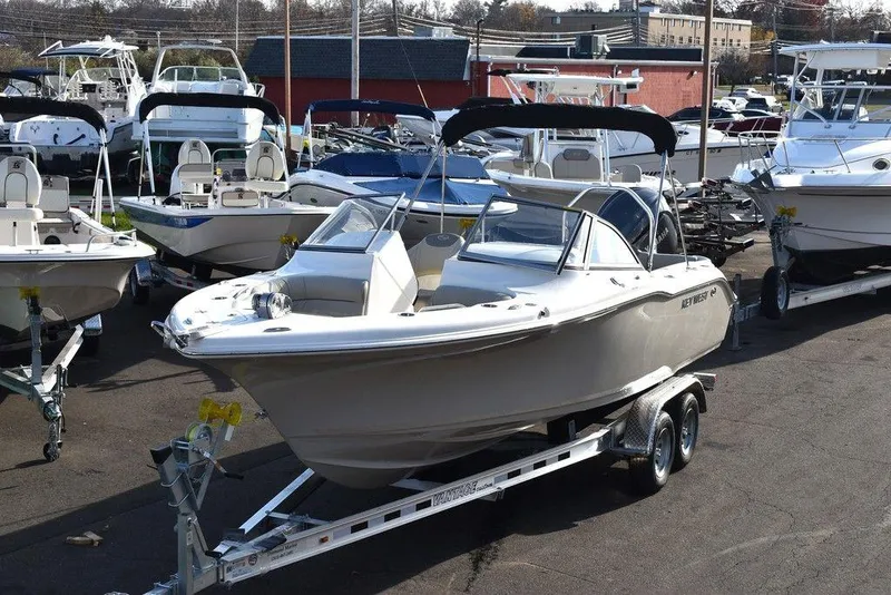 Slide: The Image of 2024 Key West 239 DFS boat on trailer in marina setting. - 9