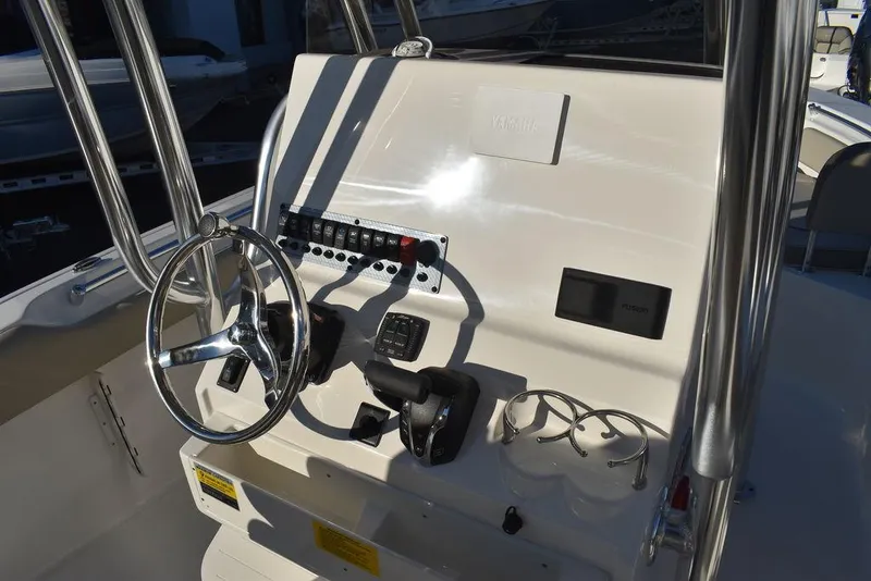 Slide: The Image of 2024 Key West 239 FS boat console with steering wheel and controls. - 14