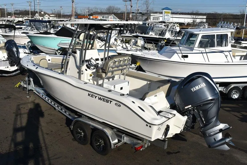Slide: The Image of 2024 Key West 239 FS boat with Yamaha engine on trailer in marina. - 2