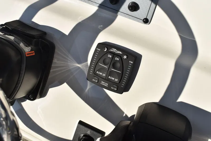 Slide: The Image of 2024 Key West 239 FS boat control panel with trim tab switches. - 22