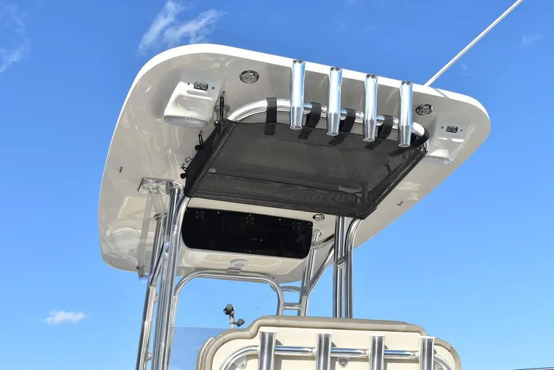 Slide: The Image of 2024 Key West 239 FS boat T-top with rod holders against blue sky. - 28