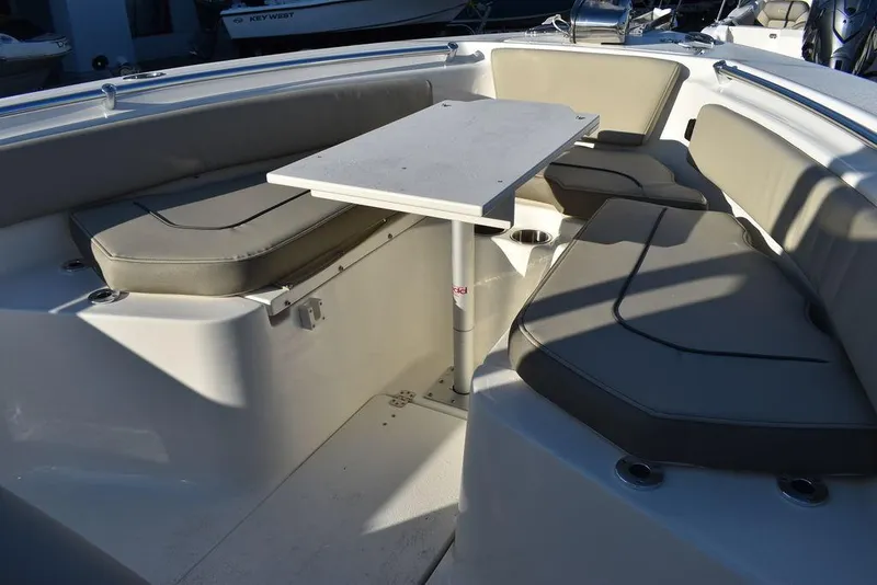 Slide: The Image of 2024 Key West 239 FS boat interior with cushioned seating and table. - 29