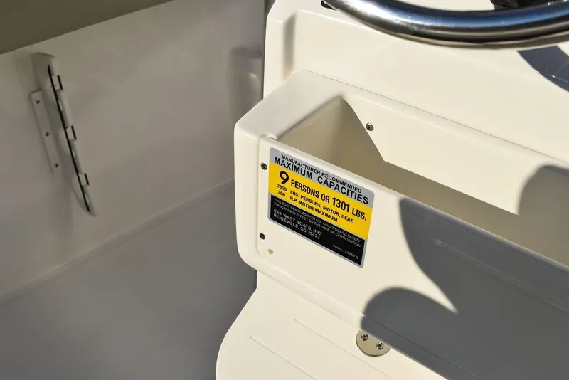 Slide: The Image of 2024 Key West 239 FS boat capacity label, maximum 9 persons or 1301 lbs. - 39