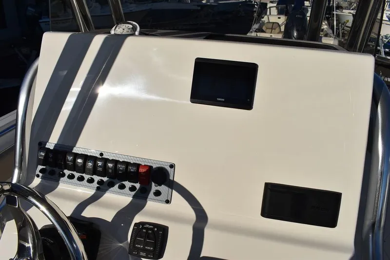 Slide: The Image of 2024 Key West 239 FS boat dashboard with controls and display screen. - 44