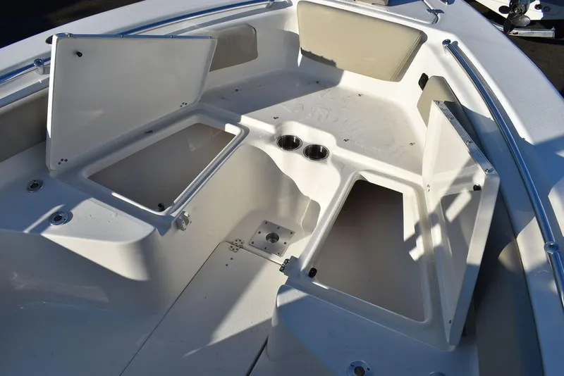 Slide: The Image of 2024 Key West 239 FS boat interior with open storage compartments and cup holders. - 45