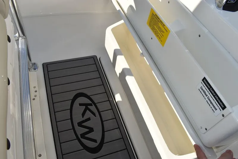 Slide: The Image of 2024 Key West 239 FS boat interior with KW logo mat and seating area. - 8