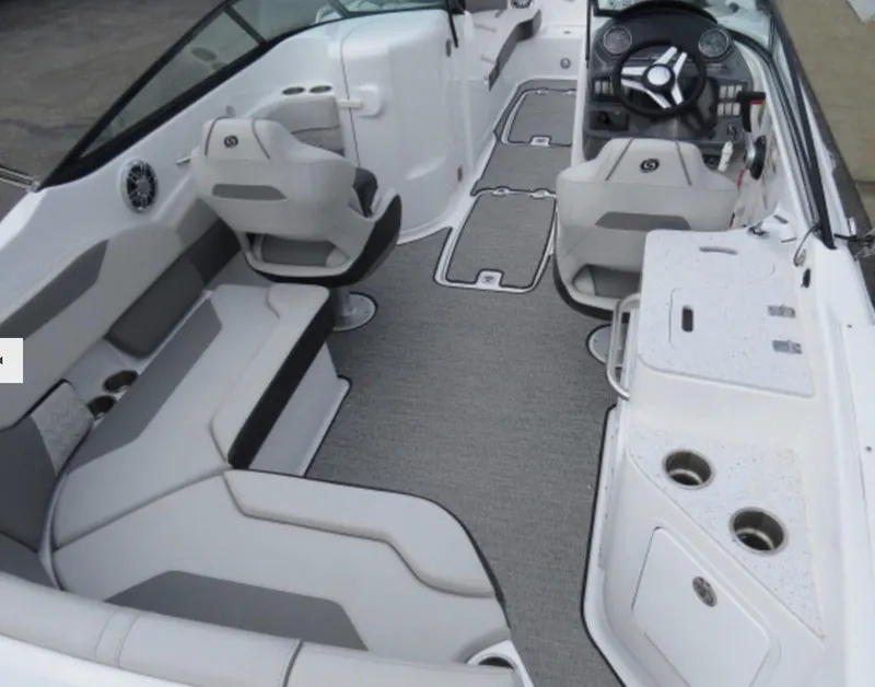 Slide: The Image of 2023 Hurricane SunDeck 2400 OB boat interior with seating, steering console, and cup holders. - 12