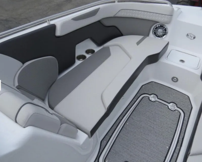 Slide: The Image of 2023 Hurricane SunDeck 2400 OB boat interior with cushioned seating and cup holders. - 18