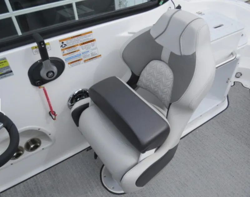 Slide: The Image of Captain's chair of 2023 Hurricane SunDeck 2400 OB boat with control panel and safety instructions. - 21