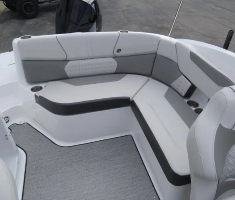 Slide: The Image of 2023 Hurricane SunDeck 2400 OB boat interior seating area with gray and white upholstery. - 27