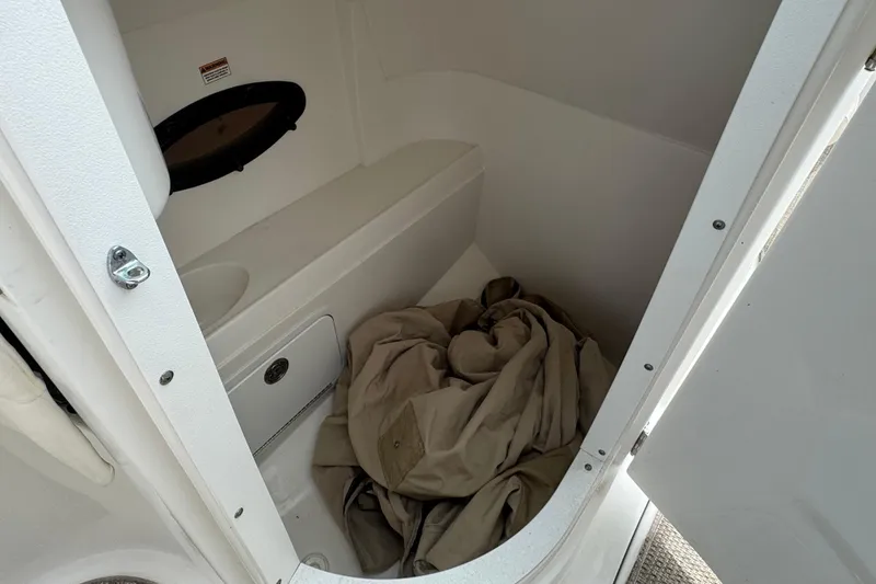 Slide: The Image of 2018 Hurricane SD 2400 I/O boat interior storage compartment with beige fabric. - 11