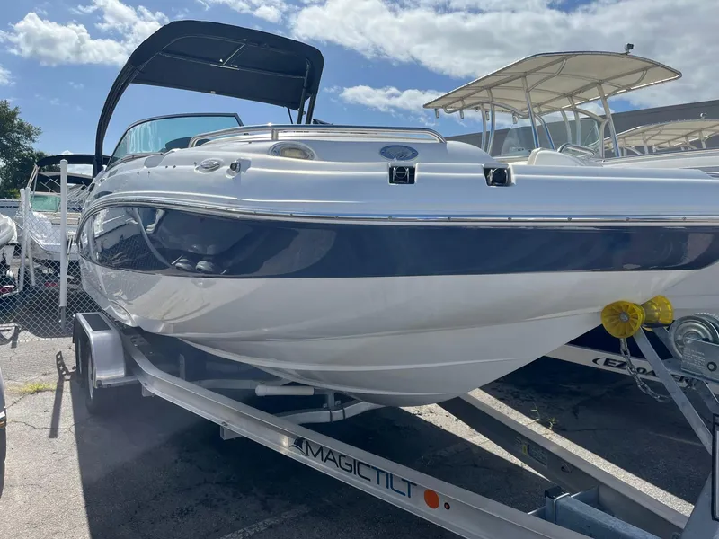 Slide: The Image of 2018 Hurricane SD 2400 I/O boat on Magic Tilt trailer, docked outdoors. - 3