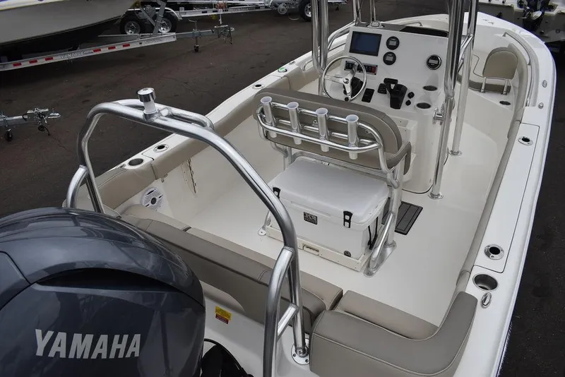 Slide: The Image of 2024 Key West 203 FS boat interior with Yamaha engine, featuring helm and seating area. - 10