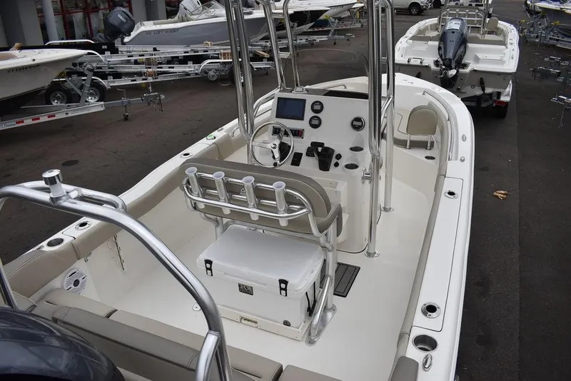Slide: The Image of 2024 Key West 203 FS boat interior with console, seating, and cooler. - 11