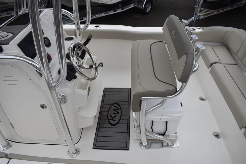 Slide: The Image of 2024 Key West 203 FS boat interior with steering console and seating. - 16