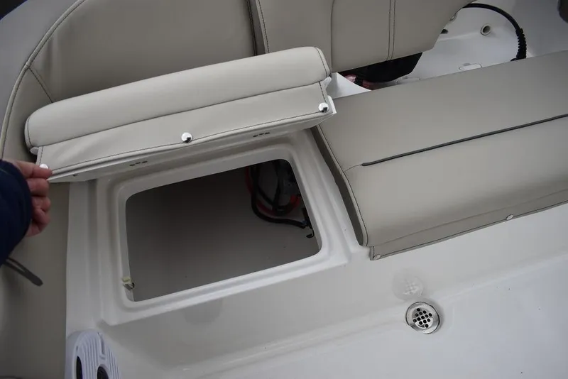 Slide: The Image of 2024 Key West 203 FS boat seat storage compartment with open lid. - 27