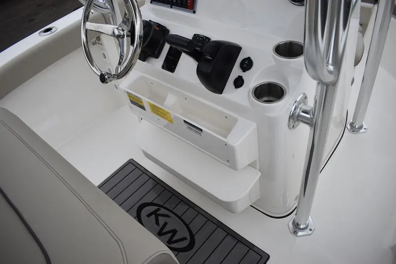 Slide: The Image of 2024 Key West 203 FS boat console with steering wheel, controls, and cup holders. - 28