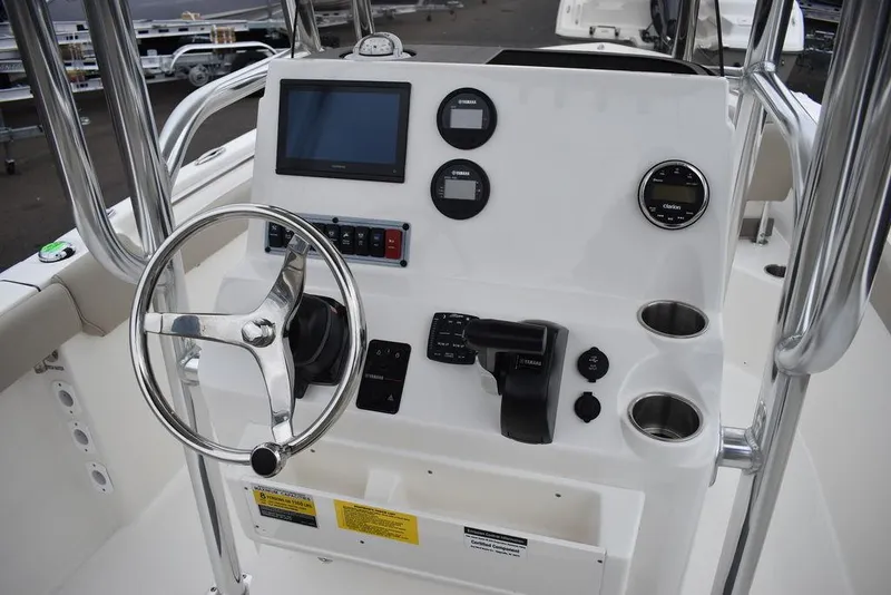 Slide: The Image of 2024 Key West 203 FS boat console with steering wheel, gauges, and controls. - 29