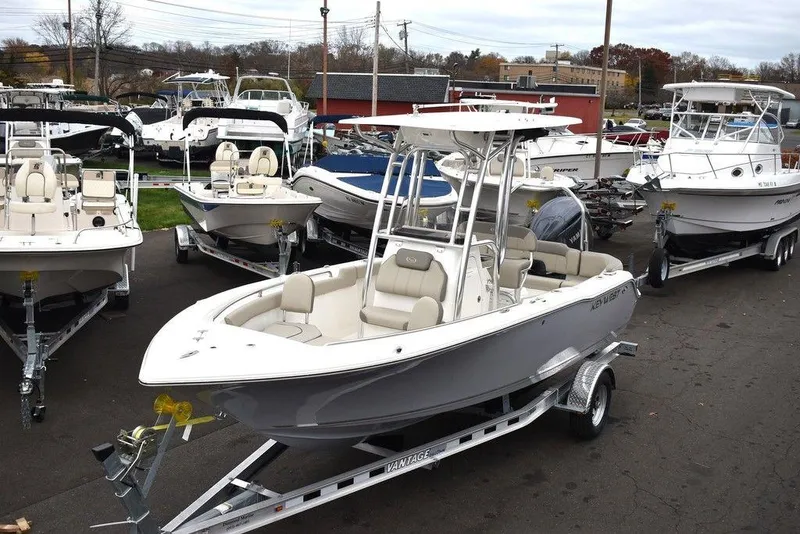 Slide: The Image of 2024 Key West 203 FS boat on trailer, surrounded by other boats in a dealership. - 3