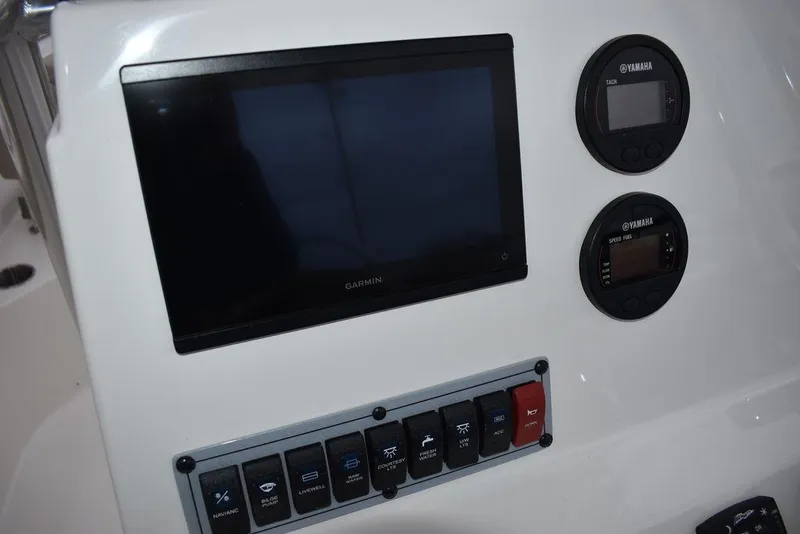 Slide: The Image of 2024 Key West 203 FS boat dashboard with Garmin display and control panel. - 30