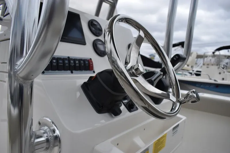 Slide: The Image of 2024 Key West 203 FS boat steering wheel and dashboard controls. - 31