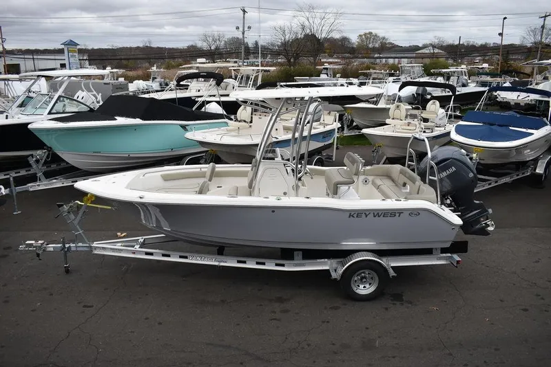 Slide: The Image of 2024 Key West 203 FS boat on trailer, surrounded by other boats in a marina. - 5