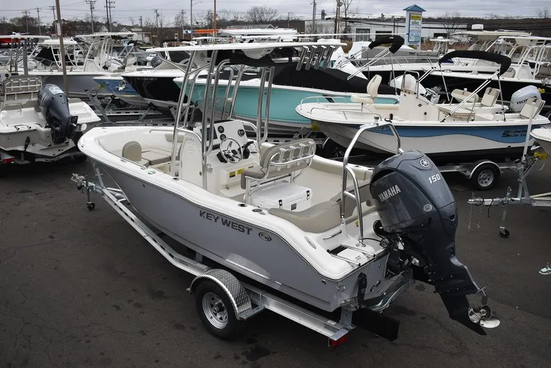 Slide: The Image of 2024 Key West 203 FS boat with Yamaha engine, displayed in a marina setting. - 6