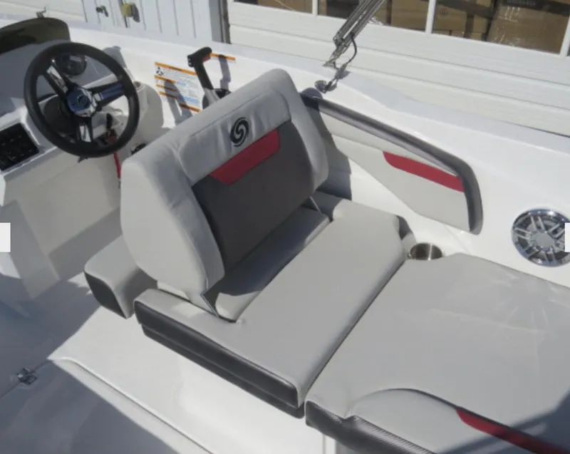 Slide: The Image of 2023 Hurricane SunDeck Sport 205 OB boat interior with steering wheel and cushioned seating. - 11