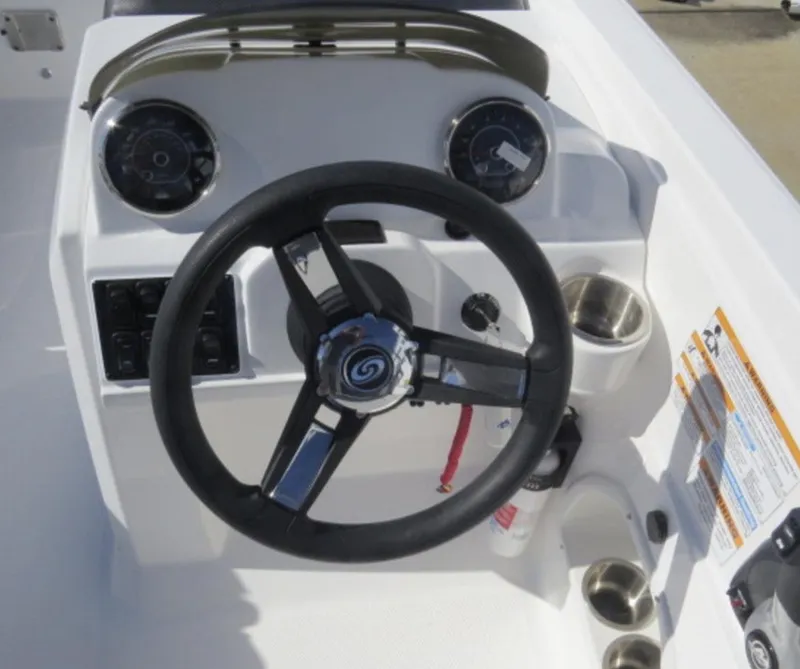 Slide: The Image of 2023 Hurricane SunDeck Sport 205 OB boat dashboard with steering wheel and gauges. - 9