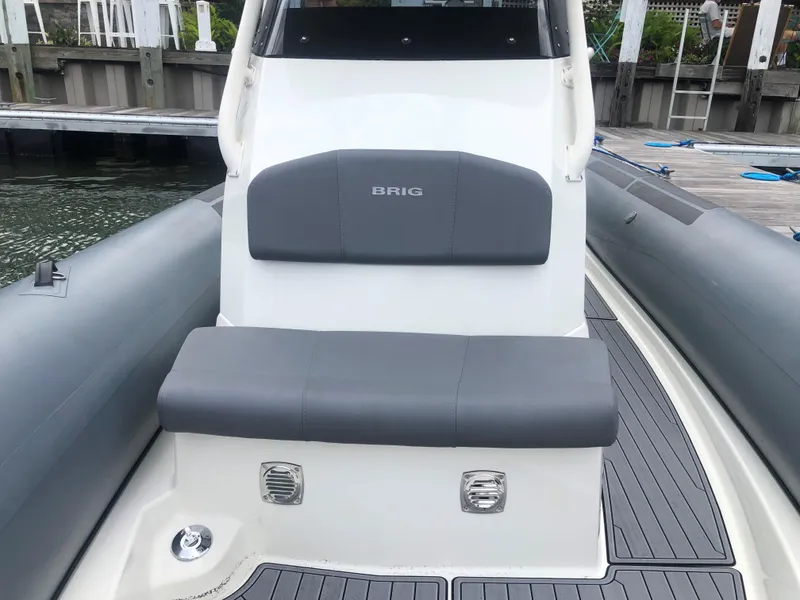 Slide: The Image of 2024 Brig Eagle 8 boat with gray seating and deck at a dock. - 10