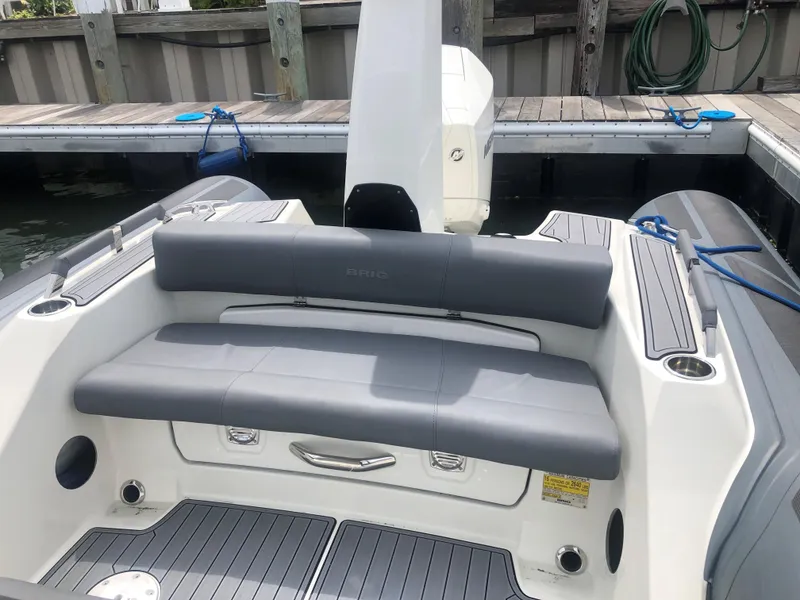Slide: The Image of 2024 Brig Eagle 8 boat with gray seating at dock. - 4