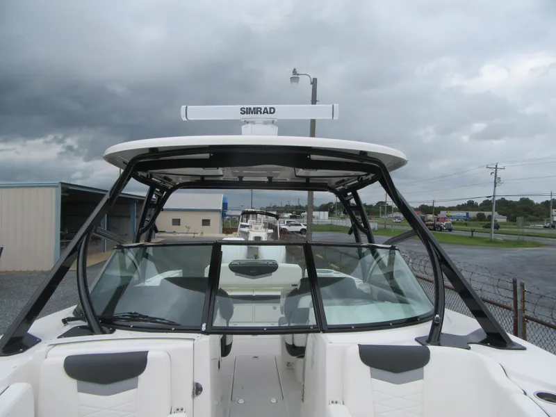 Slide: The Image of 2024 Robalo R317 Dual Console boat with Simrad radar, under cloudy skies. - 10