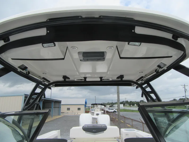 Slide: The Image of 2024 Robalo R317 Dual Console boat interior with hardtop and seating. - 11