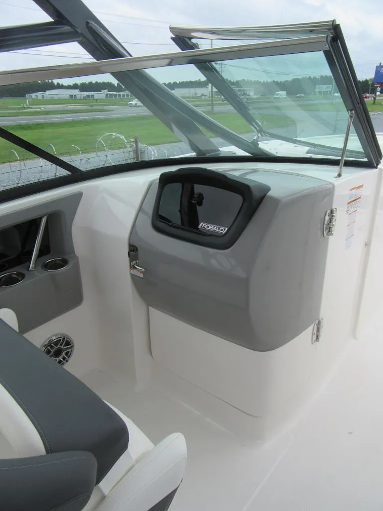 Slide: The Image of 2024 Robalo R317 Dual Console boat interior with sleek dashboard and windshield. - 13