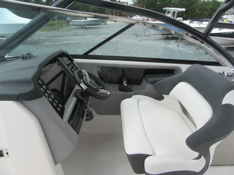 Slide: The Image of 2024 Robalo R317 Dual Console boat interior with modern dashboard and comfortable seating. - 16
