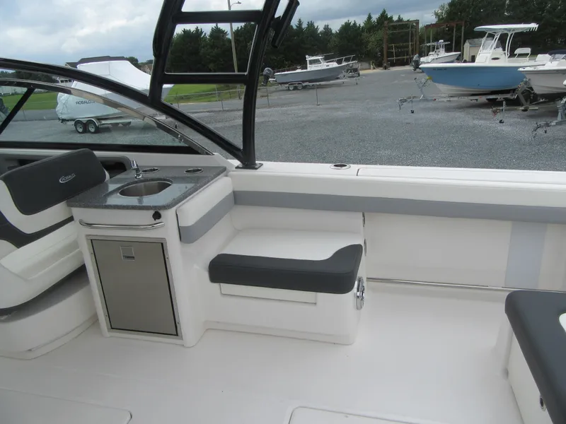 Slide: The Image of 2024 Robalo R317 Dual Console boat interior with seating and sink. - 19