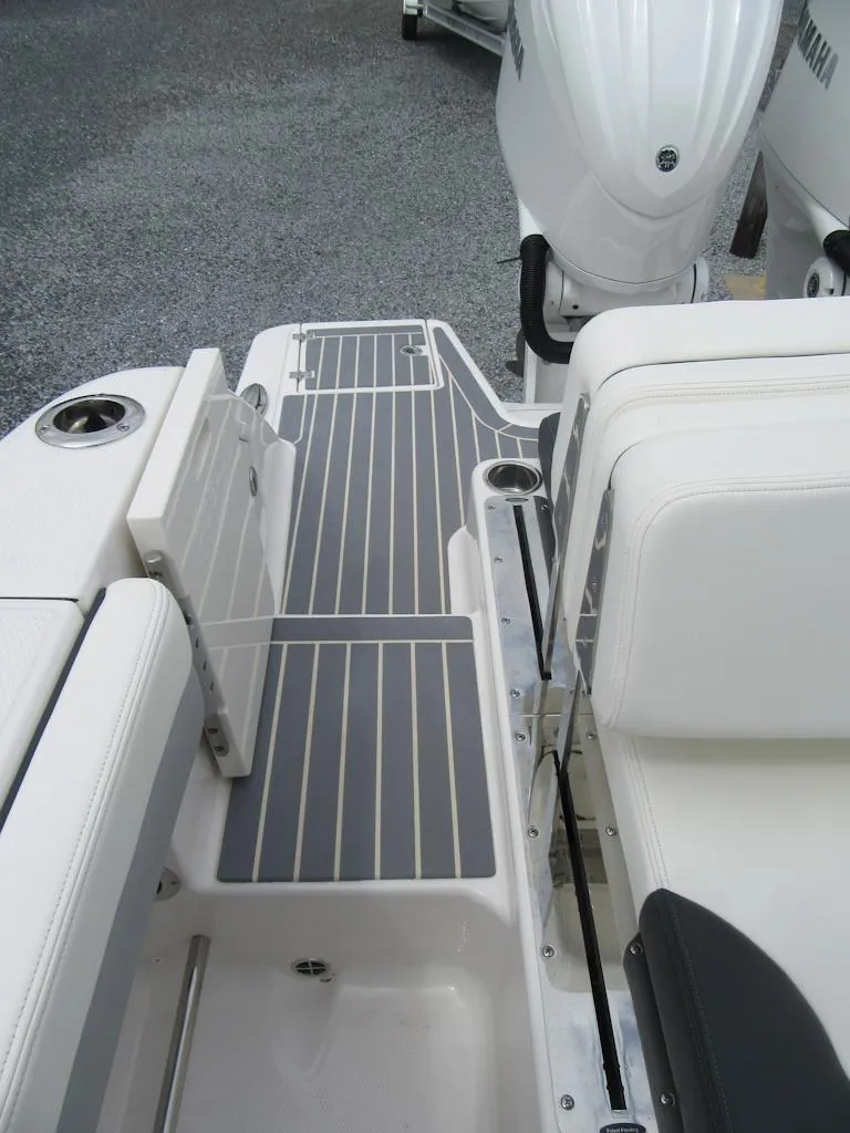 Slide: The Image of 2024 Robalo R317 Dual Console boat deck with seating and motor. - 23