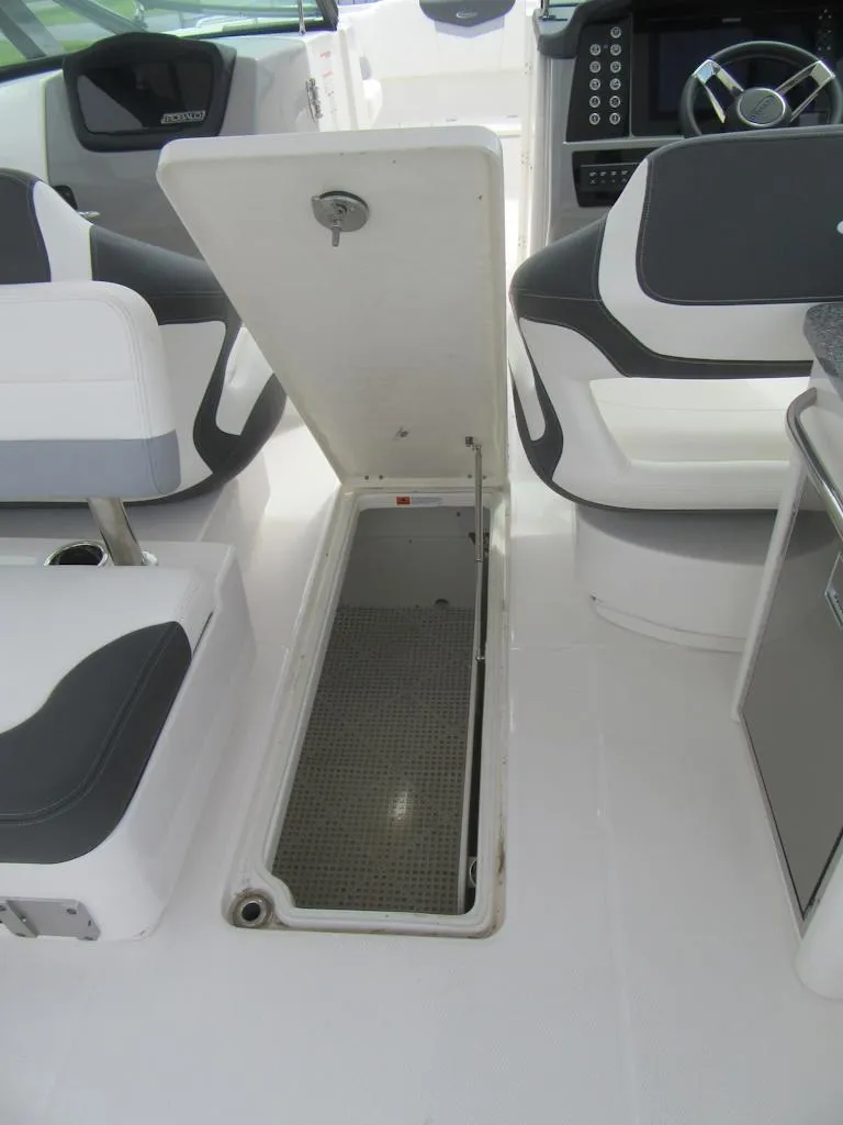 Slide: The Image of 2024 Robalo R317 Dual Console boat interior with open storage compartment. - 28