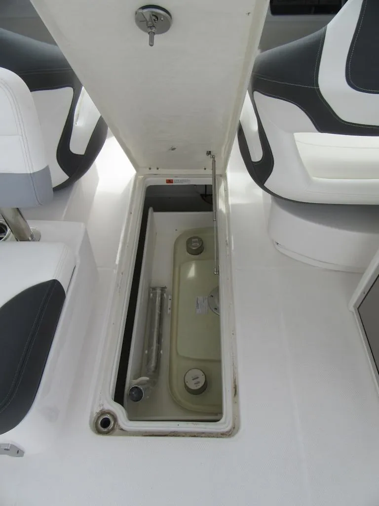 Slide: The Image of 2024 Robalo R317 Dual Console storage compartment with open hatch. - 29