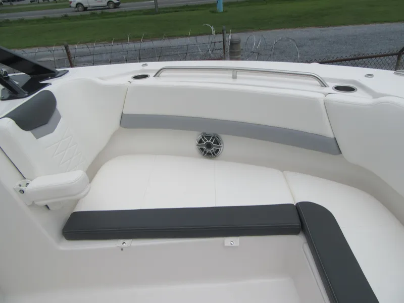 Slide: The Image of 2024 Robalo R317 Dual Console boat interior with cushioned seating and speaker. - 7