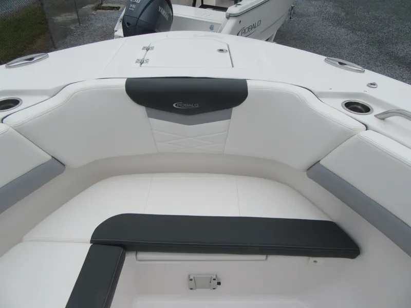 Slide: The Image of 2024 Robalo R317 Dual Console boat interior with white and gray seating. - 8