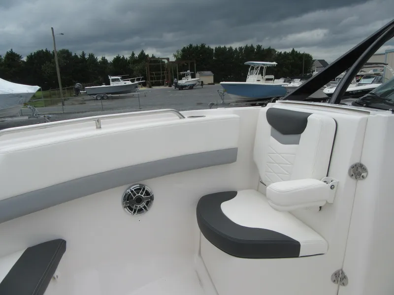 Slide: The Image of 2024 Robalo R317 Dual Console boat interior with cushioned seating and speaker. - 9