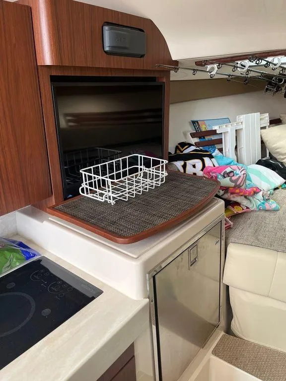 Slide: The Image of Interior of 2020 Grady-White 330 Express boat with kitchen and storage area. - 13