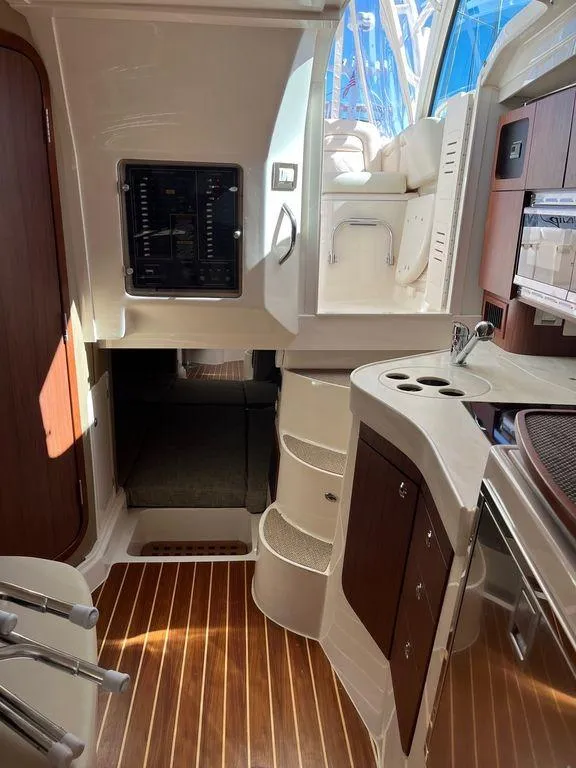 Slide: The Image of Interior of 2020 Grady-White 330 Express boat with wooden flooring and modern amenities. - 16