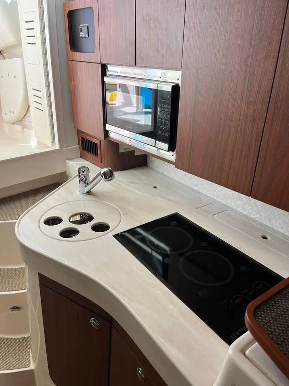 Slide: The Image of 2020 Grady-White 330 Express yacht kitchen with microwave and stovetop. - 20